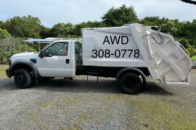 Awdisposal crew loading junk into a truck