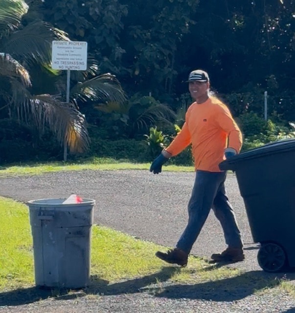 Awdisposal truck collecting weekly trash curbside